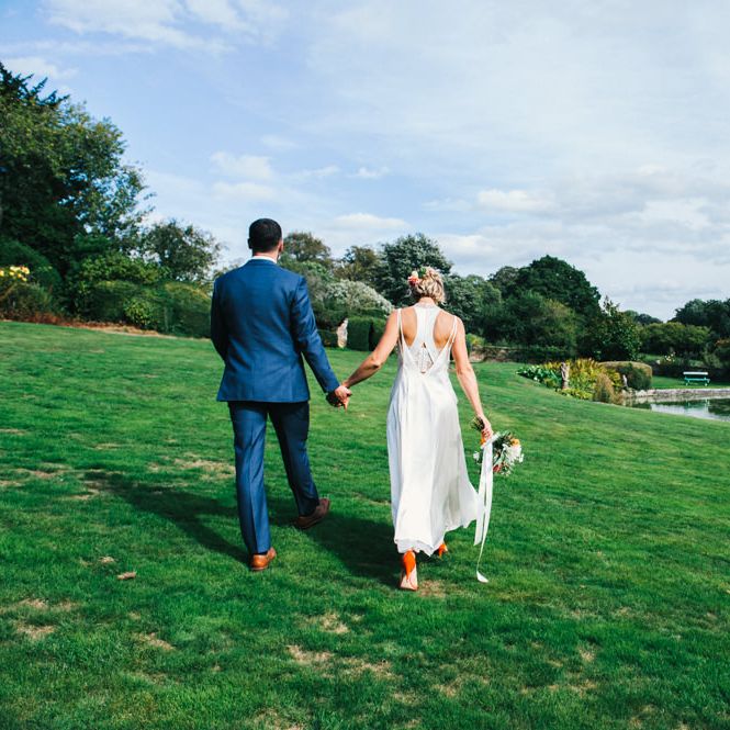 Bride in Racerback Alexander Wang Wedding Dress | Groom in Blue Ted Baker Suit | Bright Bouquet of Dahlias with Trailing Ribbon | Colourful Pennard House Wedding With Bride Wearing Racerback Dress | Allison Dewey Photography
