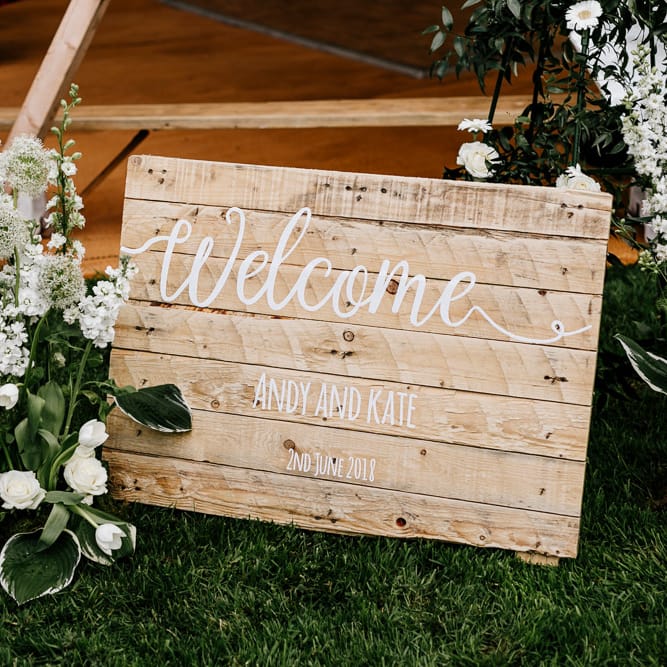 Wooden Welcome Sign For Wedding // Bride In Floral Dress By Stephanie Allin Festival Wedding With Food Trucks &amp; Outdoor Ceremony With Geo Dome Tent Baya Hire Epic Love Story Photography