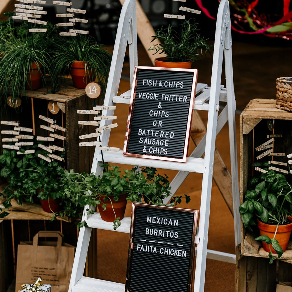 Rustic Table Plan For Wedding With Ladders // Bride In Floral Dress By Stephanie Allin Festival Wedding With Food Trucks &amp; Outdoor Ceremony With Geo Dome Tent Baya Hire Epic Love Story Photography