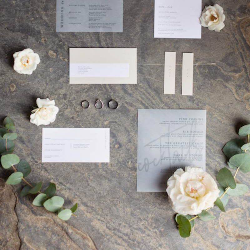 Wedding stationery and white floral decor at summer celebration