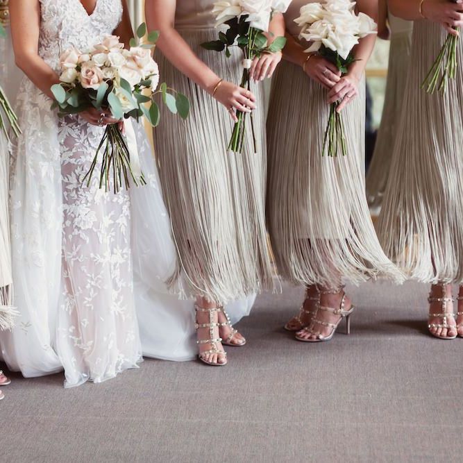 Bride wearing Zuhair Murad dress and her bridesmaids in custom made fringe dresses