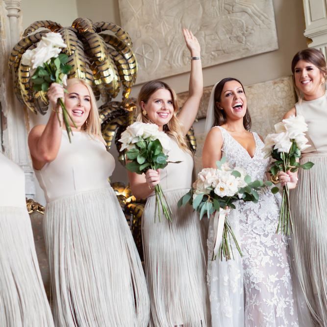 Bride wearing Zuhair Murad dress and her bridesmaids in custom made fringe dresses