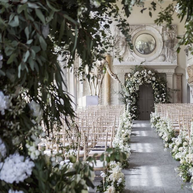 Aynhoe Park wedding ceremony with white floral decor and glitterballs