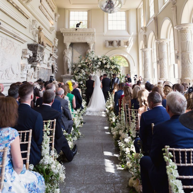 Bride and groom tie the knot at Aynhoe Park with white floral decor