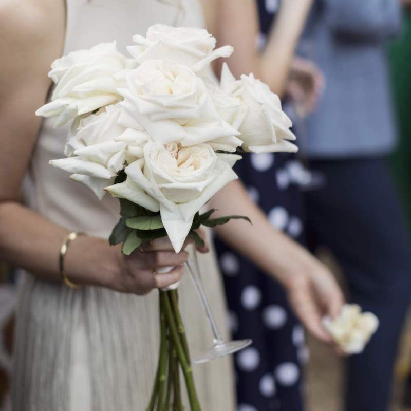 Bridesmaids beautiful fringe dress and white rose bouquet