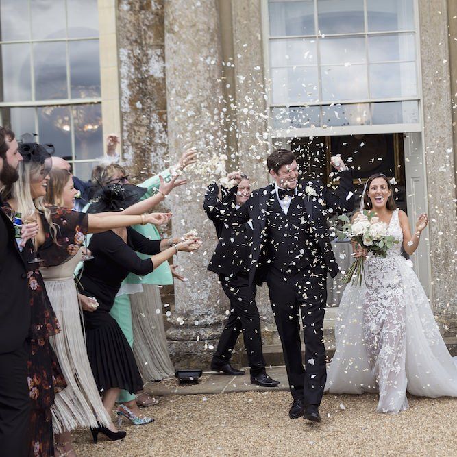 Confetti shot for bride and groom at summer wedding