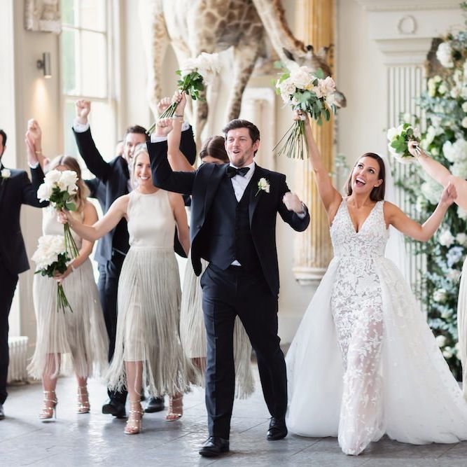 Bride and groom with the bridesmaids wearing fringe dresses and groomsmen in black tie