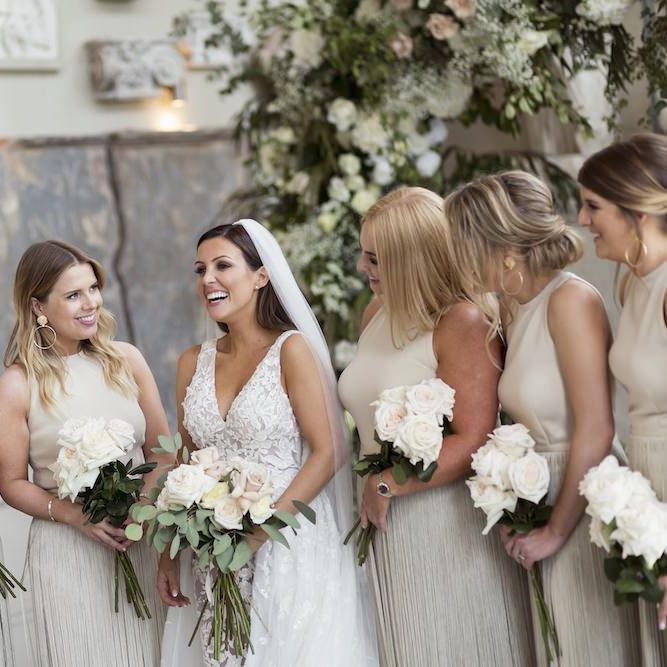 Bride wearing Zuhair Murad dress teamed with long veil and white rose bouquet