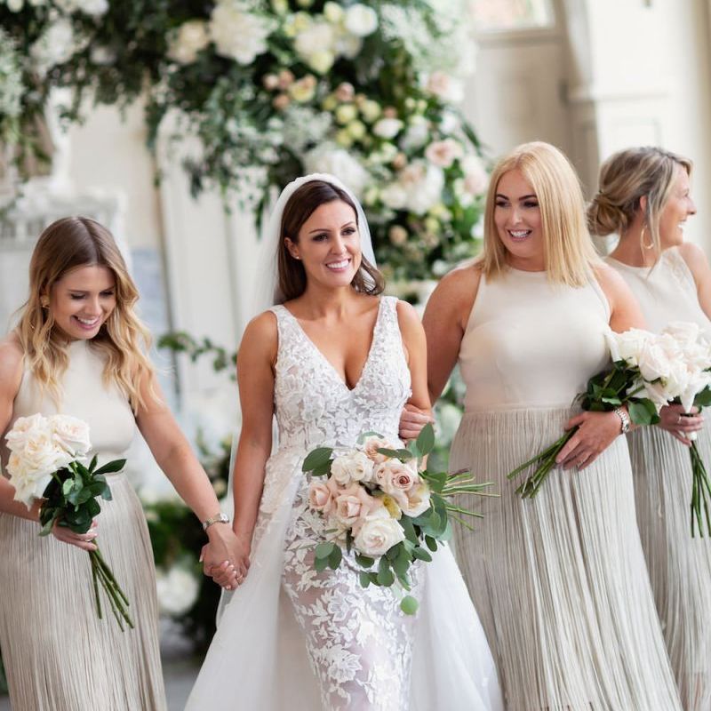 Bride wearing Zuhair Murad dress and her bridesmaids in fringe dresses