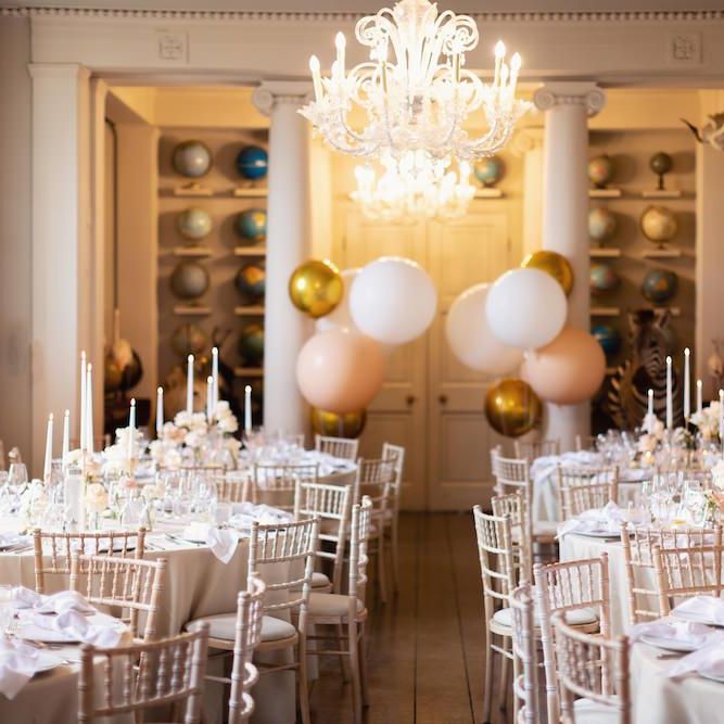 Wedding reception at Aynhoe Park with muted colour palette and balloon decor