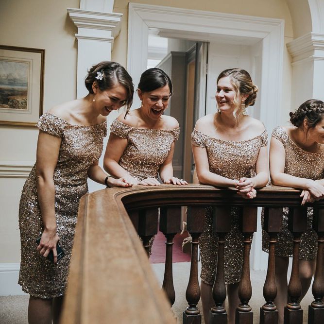 Bridesmaids in Gold Dresses Peer Over Staircase