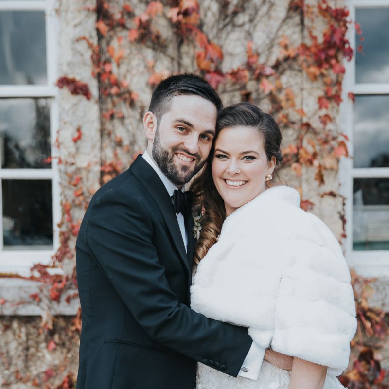 Groom Wears Tux and Bride Wears Faux Fur Cover Up For Winter Wedding at Kirtlington Park Wedding Venue