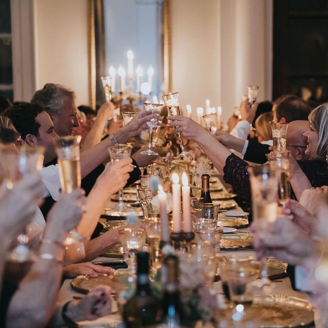 Guests Toast Bride and Groom During Speeches at Kirtlington Park Wedding Venue