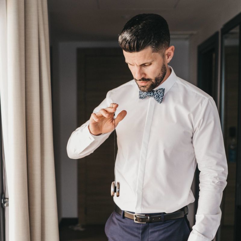 Groom in Navy Trousers, White Skirt and Floral Bow Tie