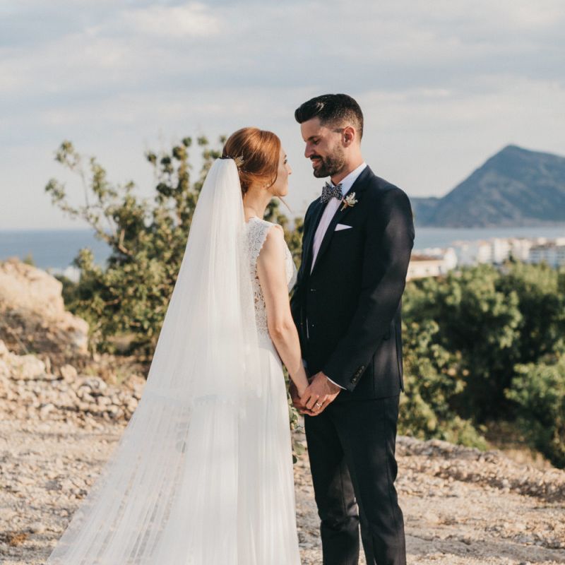 Bride and Groom Holding Hands on a Spanish Cliffside