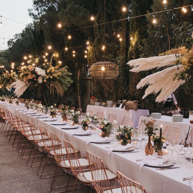 Outdoor Wedding Reception Decor with Festoon lights, Hanging Installation, Copper Vases and Chairs