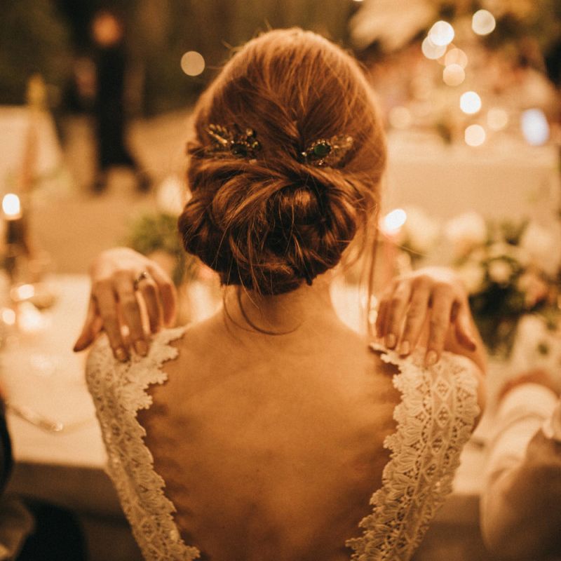 Bride in Low Back Pronovias Wedding Dress with Chic Wedding Hairstyle