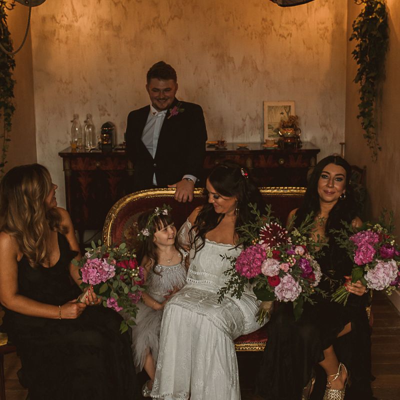 Bridal Party on the Wedding Morning with Bride in Emanuela Grace Loves Lace Off The Shoulder Wedding Dress, Bridesmaids in Black Dress and Young Daughter in a Tutu