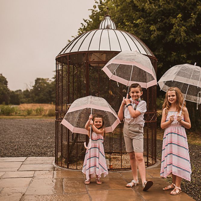 Children Holding Umbrellas
