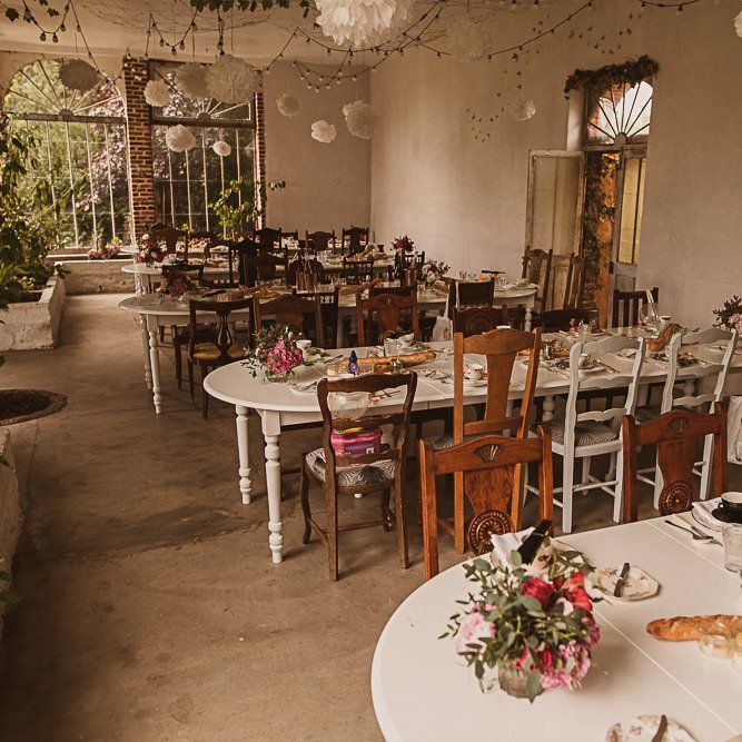 Wedding Reception Decor with Mismatch Chairs, Festoon Lights and Pompoms featured on escape to the chateau