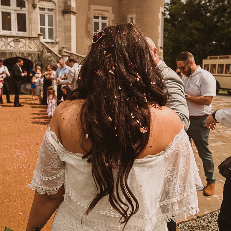Bride in Off the Shoulder Wedding Dress and Down Hair Covered in Confetti