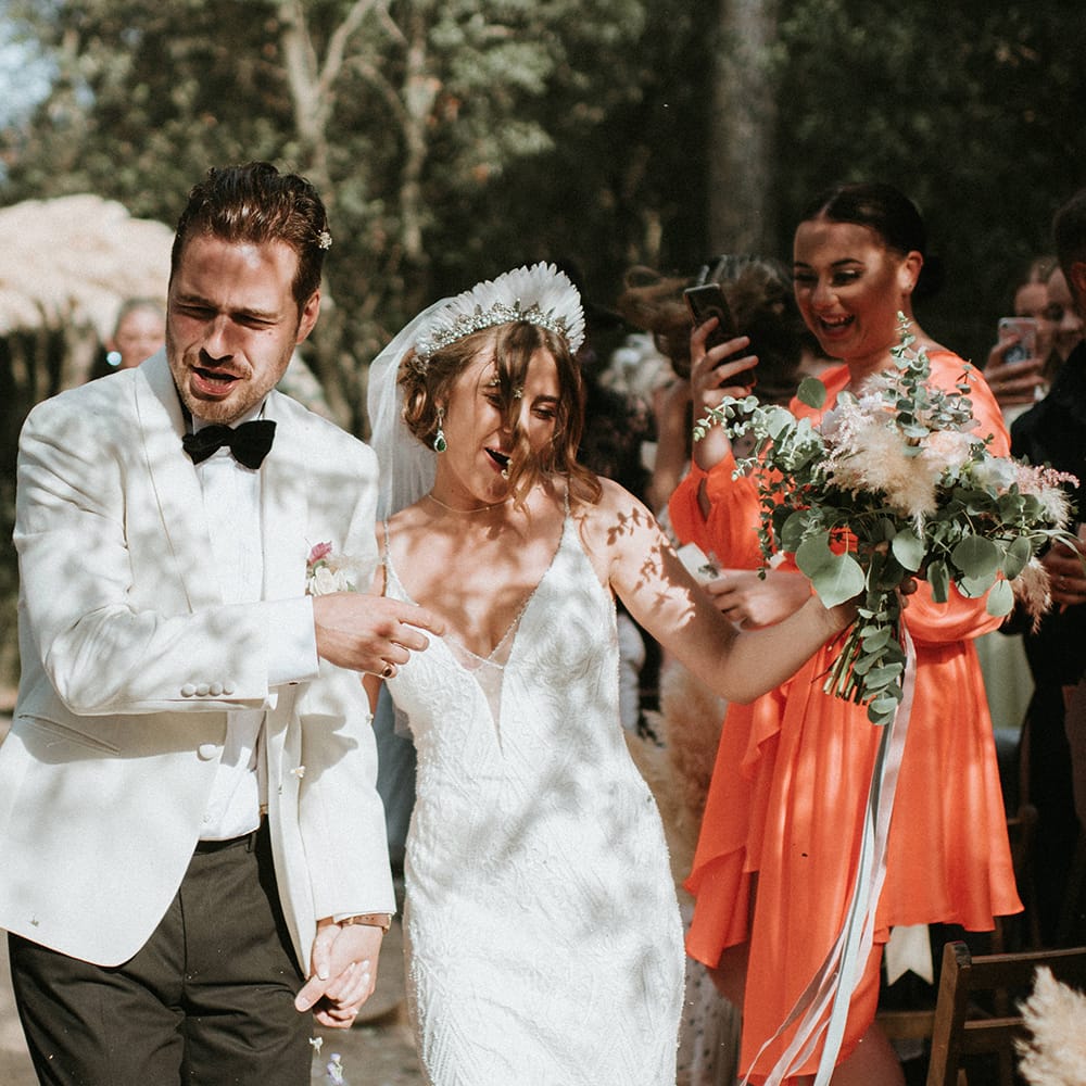 Bride And Groom Walk Up Aisle As Husband And Wife With Pampas Grass Decor