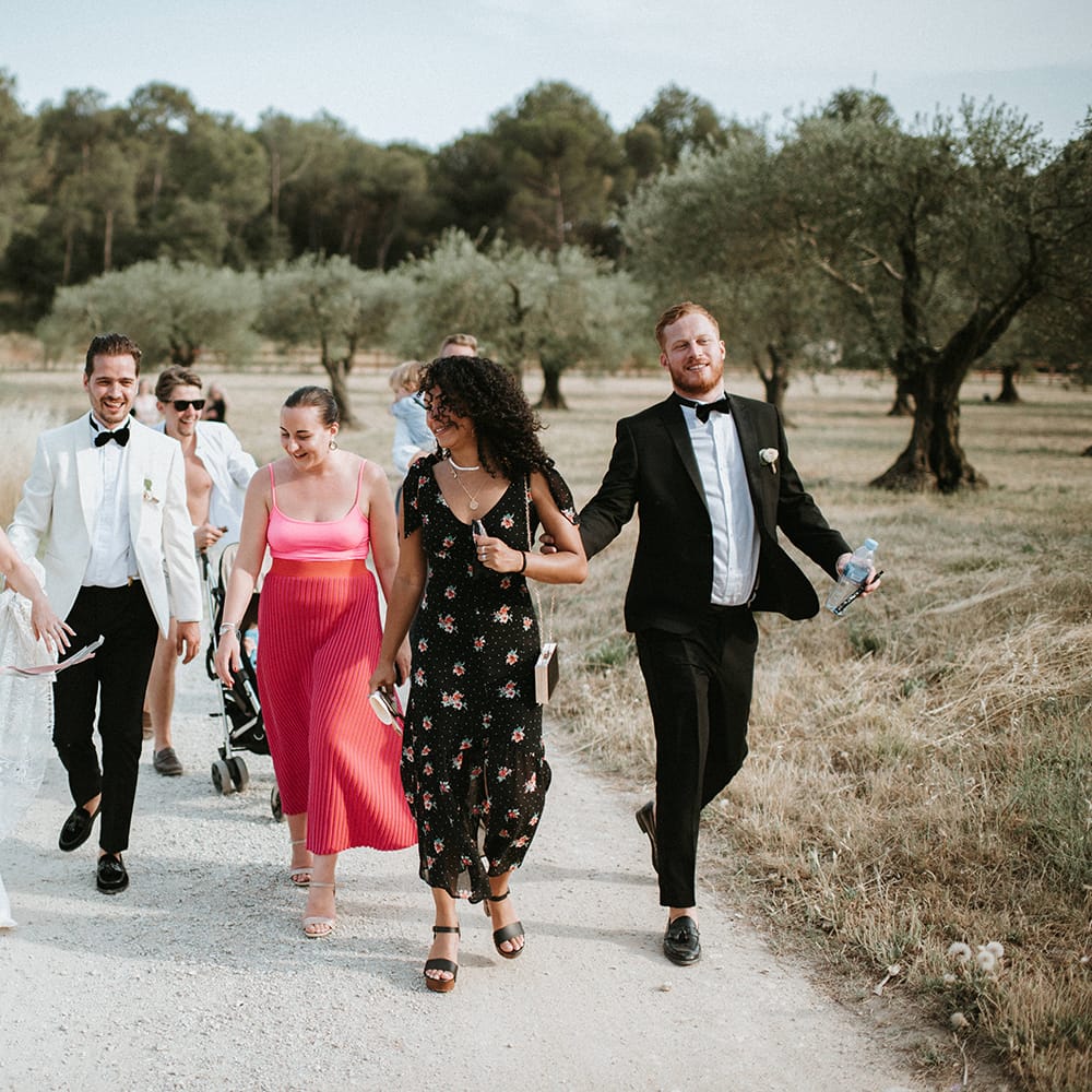 Guests Join Bride and Groom On Way To Outdoor Reception