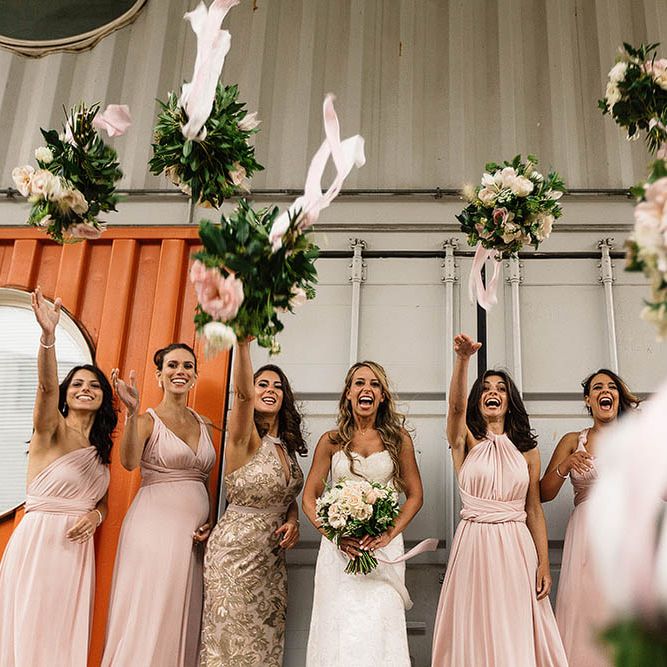 Bride In Suzanne Neville And Bridesmaids In Pink Multiway Dresses // London Wedding Venue For 300 People Trinity Buoy Wharf With Bride In Suzanne Neville And Images From Paul Joseph Photography Film This Modern Revelry