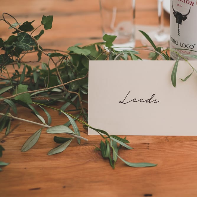 Location Table Names For Weddings // Rainy Festival Wedding In East Sussex With Bride In Rime Arodaky And Black Biker Boots And Bridesmaids In White Dresses With Silent Disco Party Images By Jesus Caballero