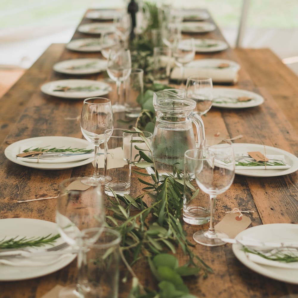 Wooden Trestle Tables For Marquee Wedding With Foliage Runners // Rainy Festival Wedding In East Sussex With Bride In Rime Arodaky And Black Biker Boots And Bridesmaids In White Dresses With Silent Disco Party Images By Jesus Caballero