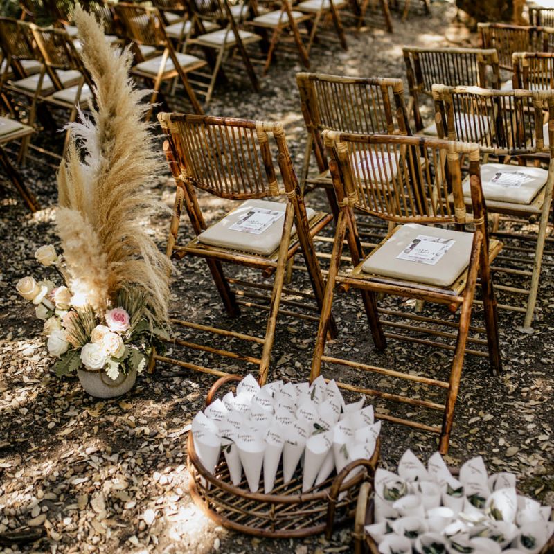 Outdoor Wedding Ceremony Decor with Bamboo Chairs, Pampas Grass Floral Arrangements and Personalised Confetti Cones