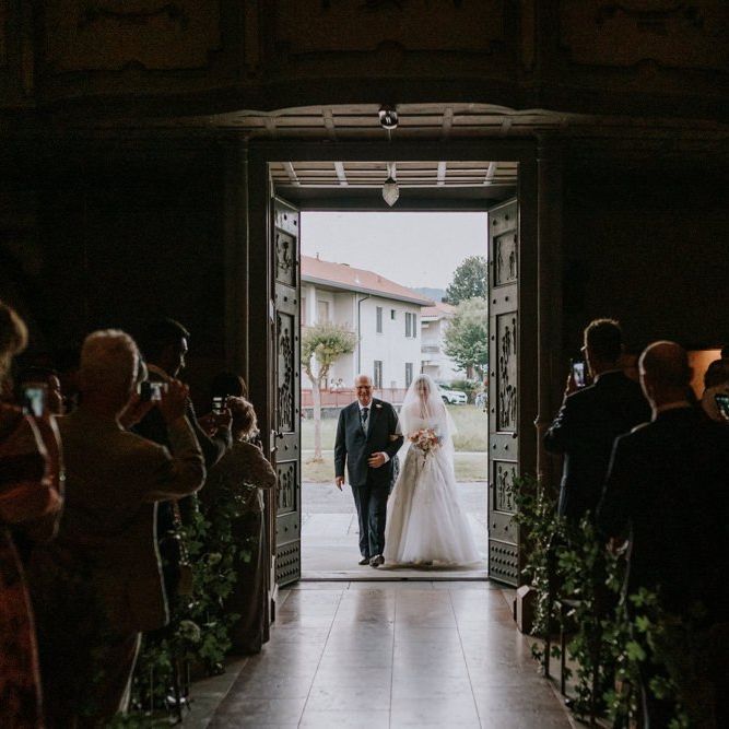 Bride carrying  pastel bouquet for wedding ceremony