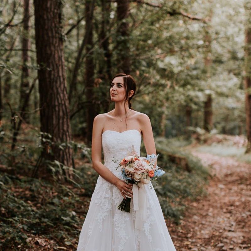 Bride in Pronovias wedding dress with pastel bouquet