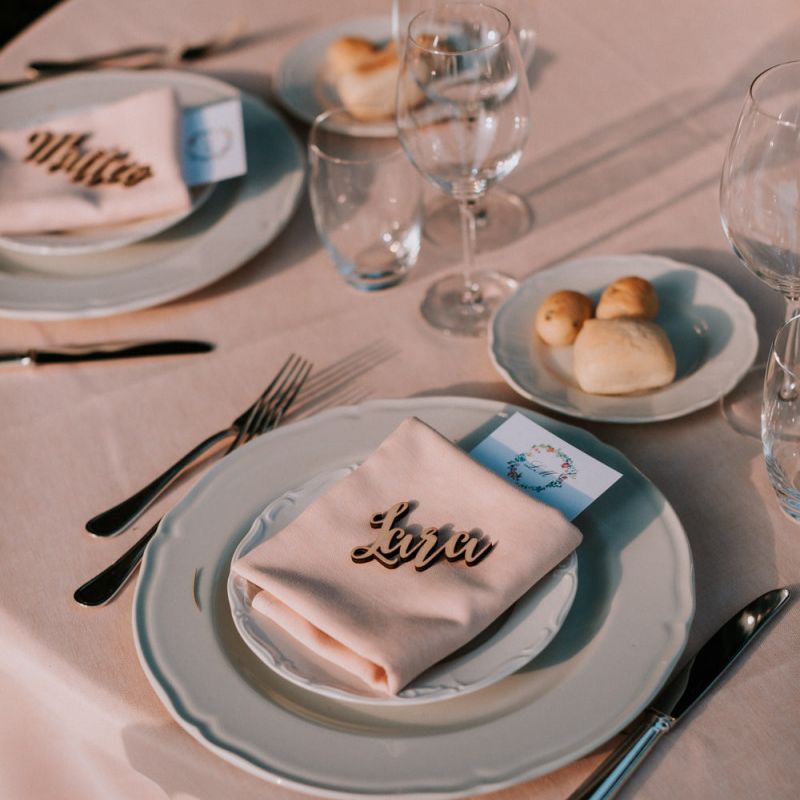 Wooden place name settings at Italian wedding