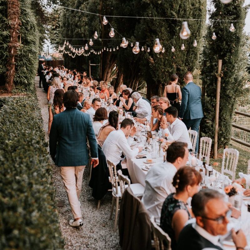 Guests enjoy romantic wedding breakfast on long banquet table