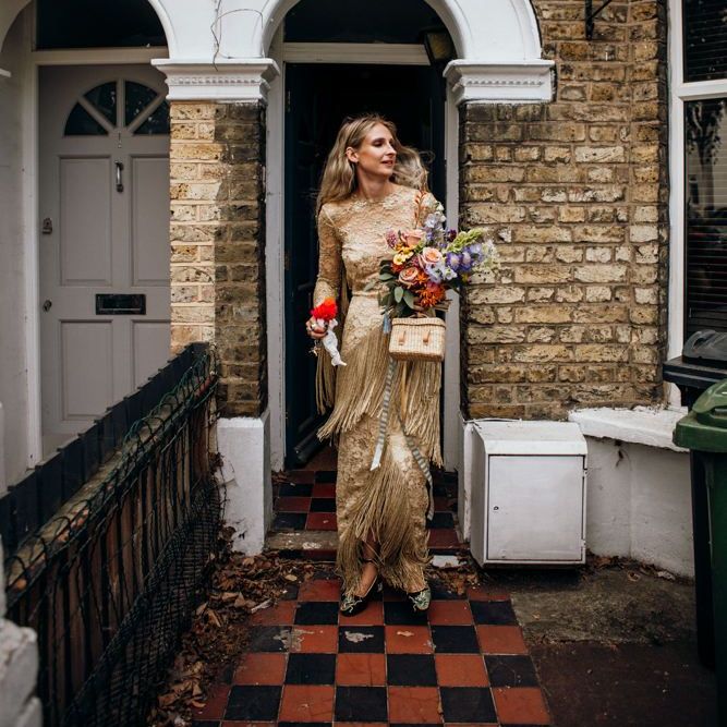 Bride on the Way to the ceremony in Gold Dress and Wedding Bouquet