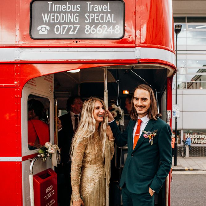 Bride and Groom on Red London Bus for Wedding Transport