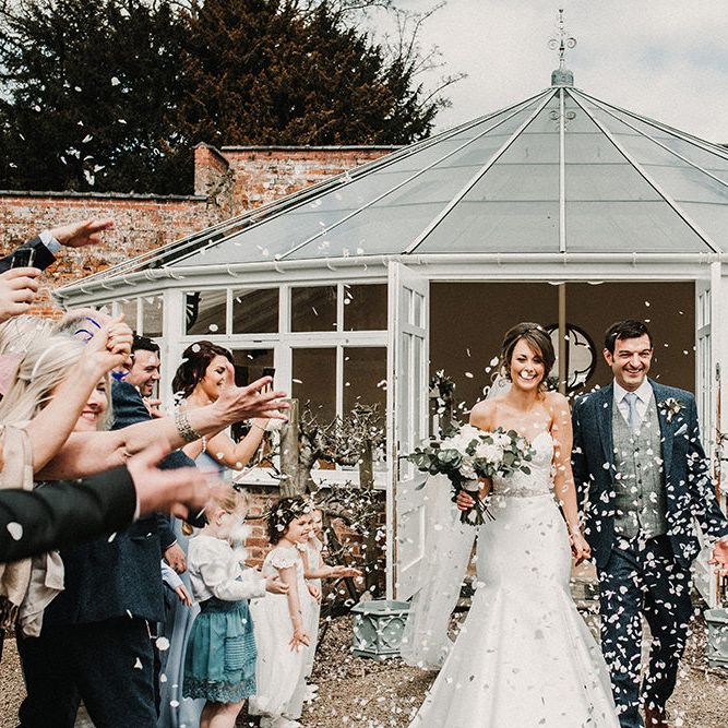 Confetti Exit | Bride in Hourglass Essense of Australia Gown | Groom in Tweed Suit | Sophisticated Wedding at Combermere Abbey, Cheshire | Carla Blain Photography