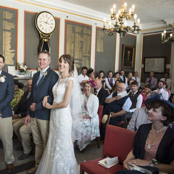 Bride in Lacy Fishtail Stella York Gown with Plunging V Back and Diamante Charm on Champagne Ribbon Belt | Groom in Blue Jacket and Waistcoat with Camel Chinos | Wedding Ceremony at Rye Town Hall | Morris Minor Wedding Car, Hanging Flowers in Bottles and Town Crier for Village Hall Wedding in Rye | Eleanor Jane Photography