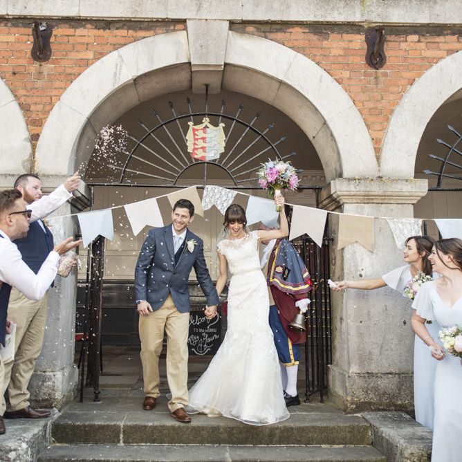 Bride in Lacy Fishtail Stella York Gown with Plunging V Back and Diamante Charm on Champagne Ribbon Belt | Summer Bridal Bouquet with Purple and Blue Flowers and Eucalyptus | Groom in Blue Jacket and Waistcoat with Camel Chinos | Wedding Ceremony at Rye Town Hall | Morris Minor Wedding Car, Hanging Flowers in Bottles and Town Crier for Village Hall Wedding in Rye | Eleanor Jane Photography