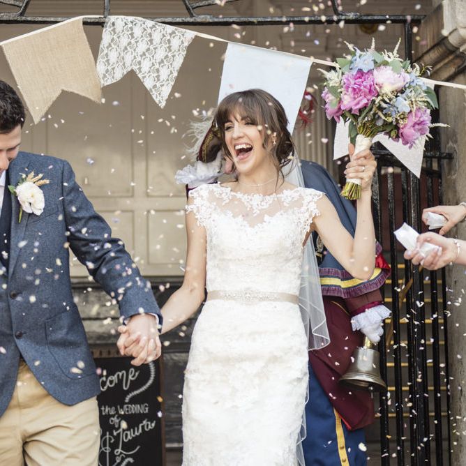 Bride in Lacy Fishtail Stella York Gown with Plunging V Back and Diamante Charm on Champagne Ribbon Belt | Summer Bridal Bouquet with Purple and Blue Flowers and Eucalyptus | Groom in Blue Jacket and Waistcoat with Camel Chinos | Giant Pastel Bunting Flags | Wedding Ceremony at Rye Town Hall | Morris Minor Wedding Car, Hanging Flowers in Bottles and Town Crier for Village Hall Wedding in Rye | Eleanor Jane Photography