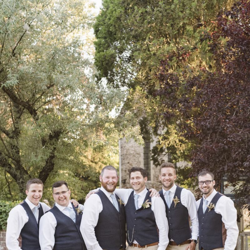 Groom and Groomsmen in Blue Waistcoats with Camel Chinos and Baby Blue Ties | Morris Minor Wedding Car, Hanging Flowers in Bottles and Town Crier for Village Hall Wedding in Rye | Eleanor Jane Photography