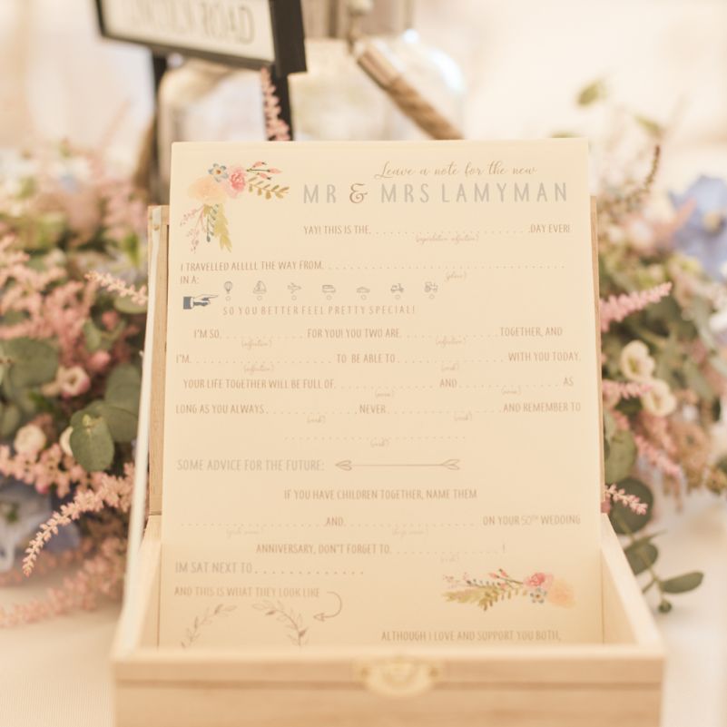 Wedding Advice Cards | Flower Garland Centrepieces | Tipi Wedding Reception at Udimore Village Hall, East Sussex | Morris Minor Wedding Car, Hanging Flowers in Bottles and Town Crier for Village Hall Wedding in Rye | Eleanor Jane Photography