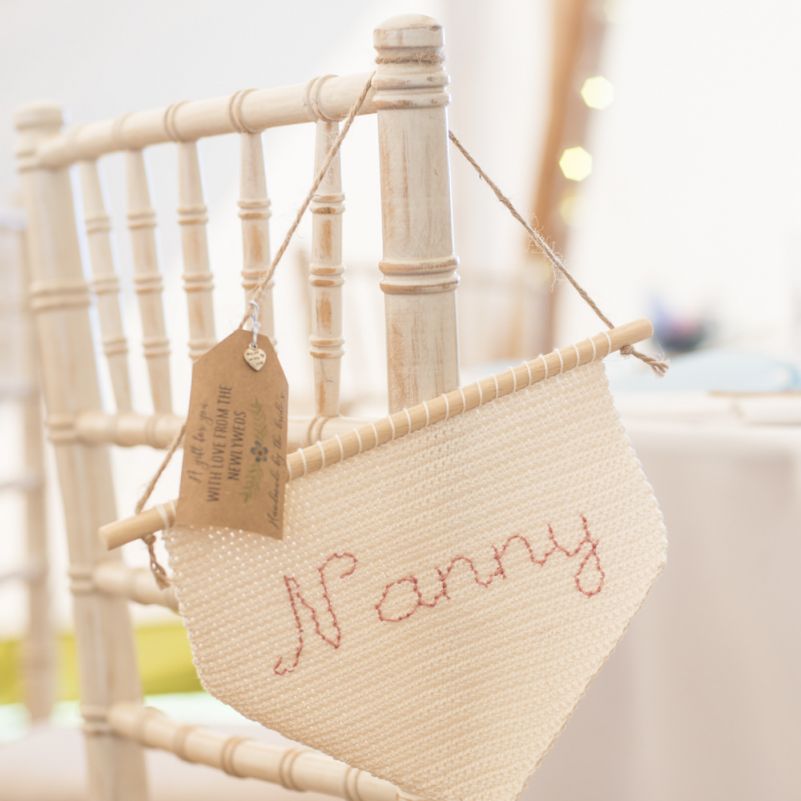 Personalised Flag Wedding Favours | Tipi Wedding Reception at Udimore Village Hall, East Sussex | Morris Minor Wedding Car, Hanging Flowers in Bottles and Town Crier for Village Hall Wedding in Rye | Eleanor Jane Photography
