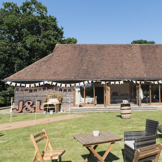 Tipi Wedding Reception at Udimore Village Hall, East Sussex | Giant Flag Bunting | Copper Letter Lights | Fire Pits | Morris Minor Wedding Car, Hanging Flowers in Bottles and Town Crier for Village Hall Wedding in Rye | Eleanor Jane Photography