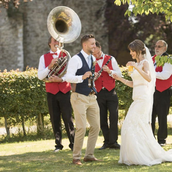Bride in Lacy Fishtail Stella York Gown with Plunging V Back and Diamante Charm on Champagne Ribbon Belt | Jazz Band | Morris Minor Wedding Car, Hanging Flowers in Bottles and Town Crier for Village Hall Wedding in Rye | Eleanor Jane Photography