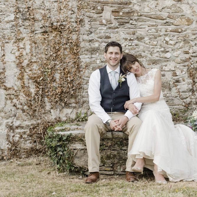 Bride in Lacy Fishtail Stella York Gown with Plunging V Back and Diamante Charm on Champagne Ribbon Belt | Floral Embroidered Chloe Shoes by Bella Belle | Groom in Blue Jacket and Waistcoat with Camel Chinos | Morris Minor Wedding Car, Hanging Flowers in Bottles and Town Crier for Village Hall Wedding in Rye | Eleanor Jane Photography