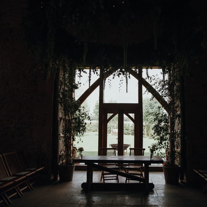 Suspended Foliage For Barn Wedding // Glastonbury Themed Table Plan For Wedding At Stone Barn Cotwolds With Groom In Cad &amp; The Dandy Images Meghan Lorna