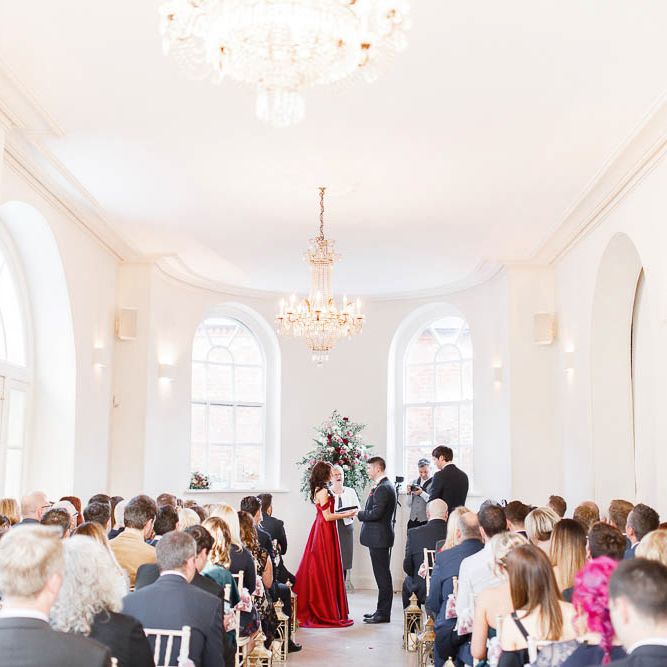 Wedding Ceremony | Bride in Bespoke Red Gown from agape Bridal Boutique | Groom in Slaters Suit | Red New Years Eve Winter Wedding at Iscoyd Park, Shropshire | White Stag Wedding Photography | Lovetwofilm