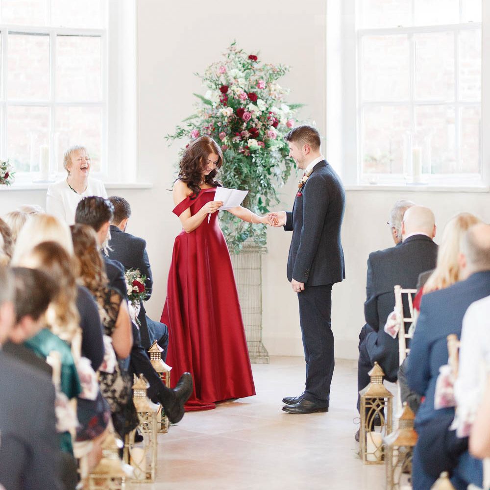 Wedding Ceremony | Bride in Bespoke Red Gown from agape Bridal Boutique | Groom in Slaters Suit | Red New Years Eve Winter Wedding at Iscoyd Park, Shropshire | White Stag Wedding Photography | Lovetwofilm